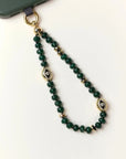 Emerald Leah Phone Charm displayed in looped form, highlighting gemstone color and gold finishes.