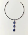 Silver necklace with blue evil eye pendant on a white background