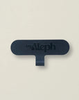 A single black MyAleph Phone Charm Attachment Card against a neutral background, showing its compact and durable design.