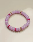 Close-up view of a single valerie lavender bracelet from the set of three, highlighting its soft purple beads with pink and gold dividers arranged in a circular layout.