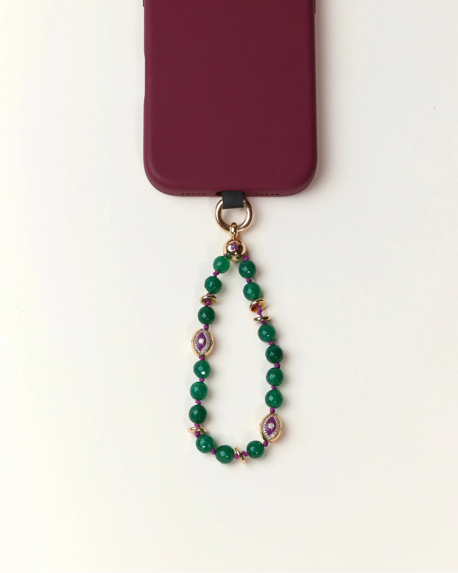 Green beaded phone charm with a purple heart pendant on a white background