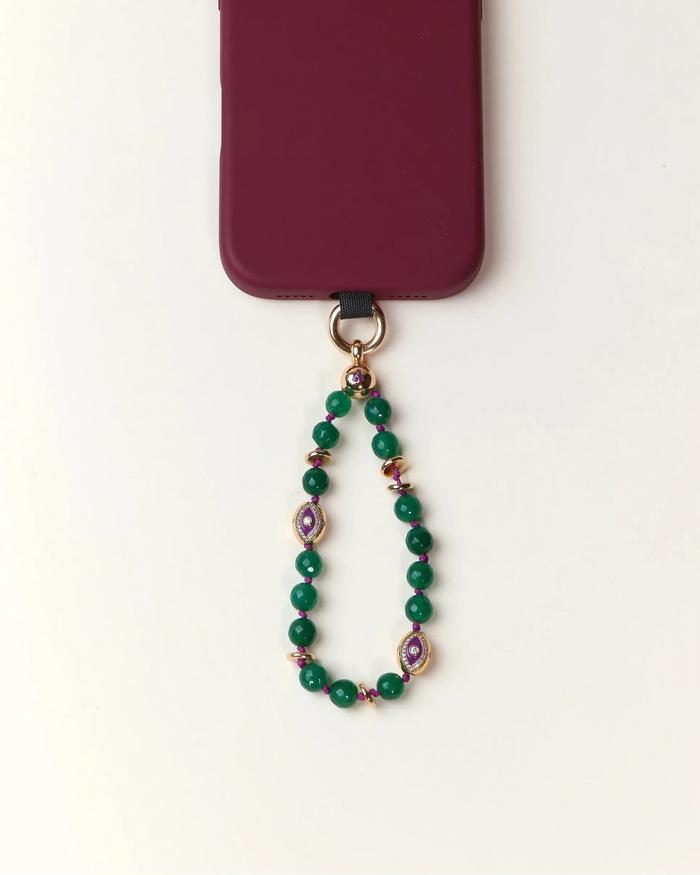 Green beaded phone charm with a purple heart pendant on a white background