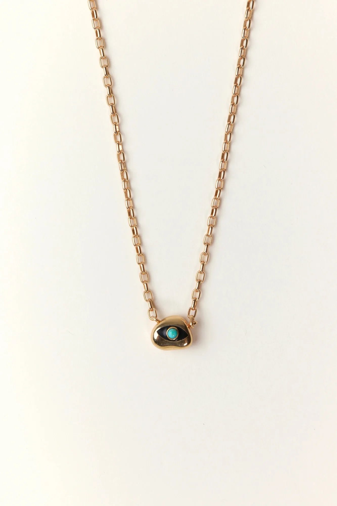 Aura Evil Eye necklace with a turquoise gemstone set in a gold plated pendant on a fine chain, styled as a luxury protective talisman.