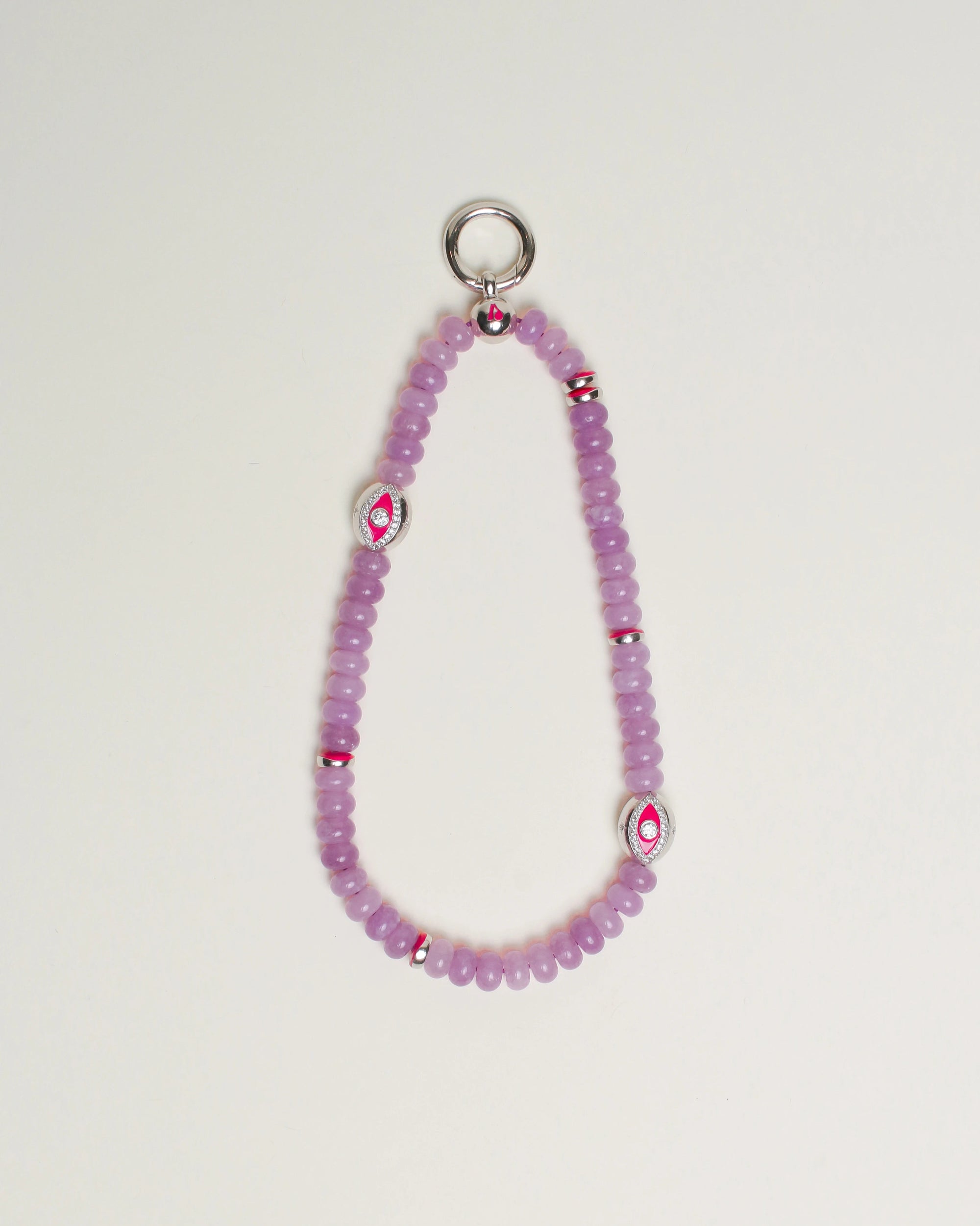 Close-up of Leah Bag Charm in Lavender – A refined bag charm featuring semi-precious lavender quartz beads and sterling silver rhodium-plated Evil Eye charms, designed for style and protection.