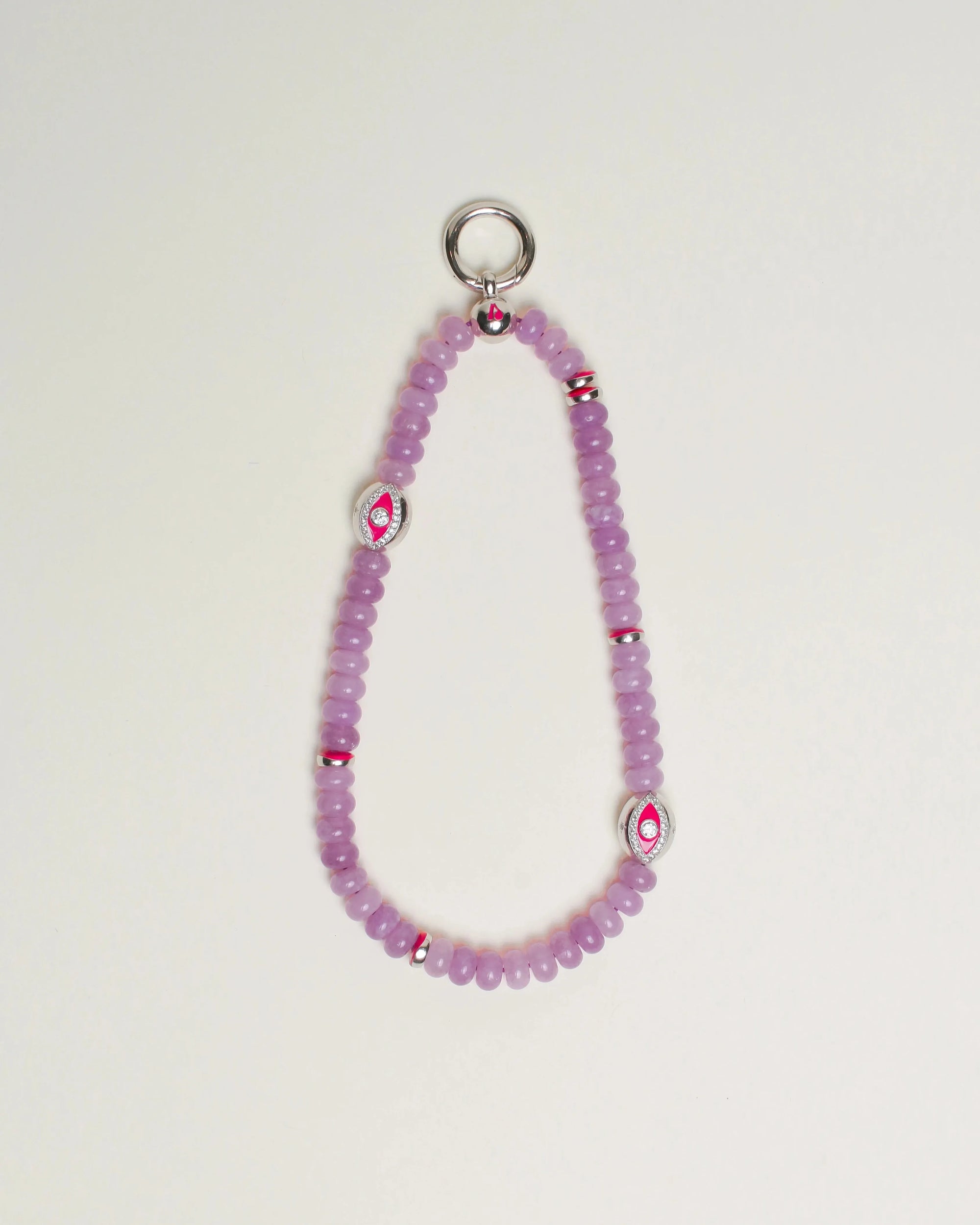 Close-up of Leah Bag Charm in Lavender – A refined bag charm featuring semi-precious lavender quartz beads and sterling silver rhodium-plated Evil Eye charms, designed for style and protection.