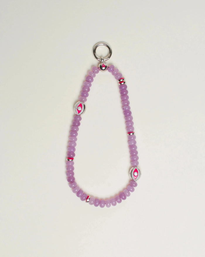 Close-up of Leah Bag Charm in Lavender – A refined bag charm featuring semi-precious lavender quartz beads and sterling silver rhodium-plated Evil Eye charms, designed for style and protection.