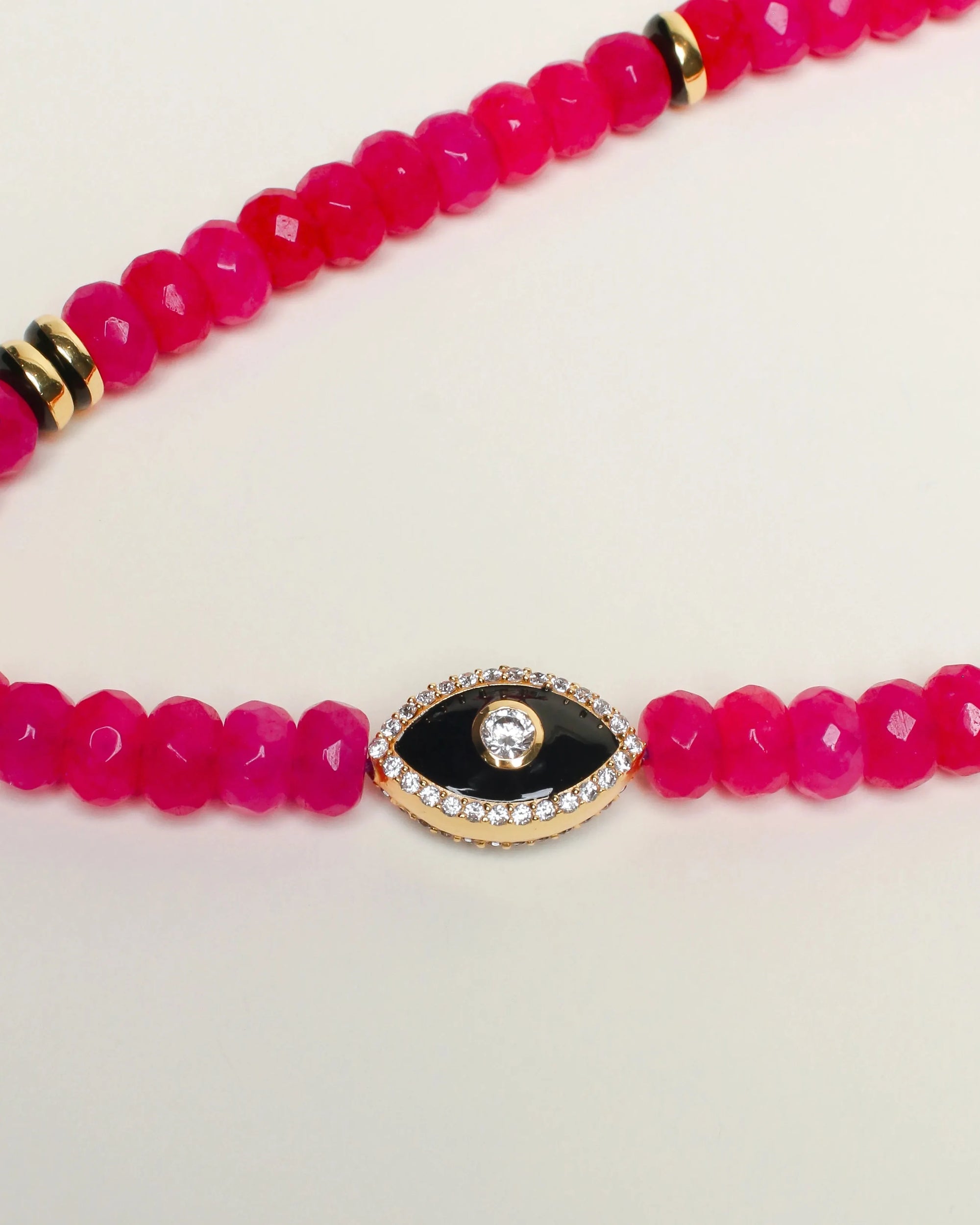 Flat lay of Stella Bag Charm with Evil Eye detail – A detailed view showcasing the pink quartz beads and the zirconia diamond Evil Eye charm, highlighting its protective energy.