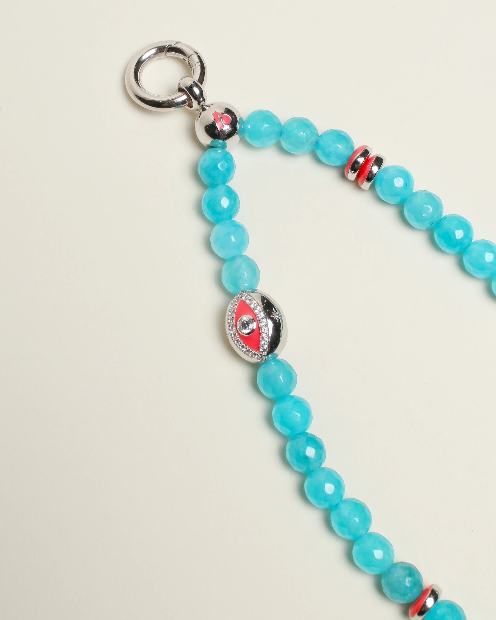 The Leah Bag Charm in Turquoise displayed in full view, featuring vibrant turquoise quartz beads, silver Evil Eye charms, and polished pink dividers for a luxe, meaningful design.