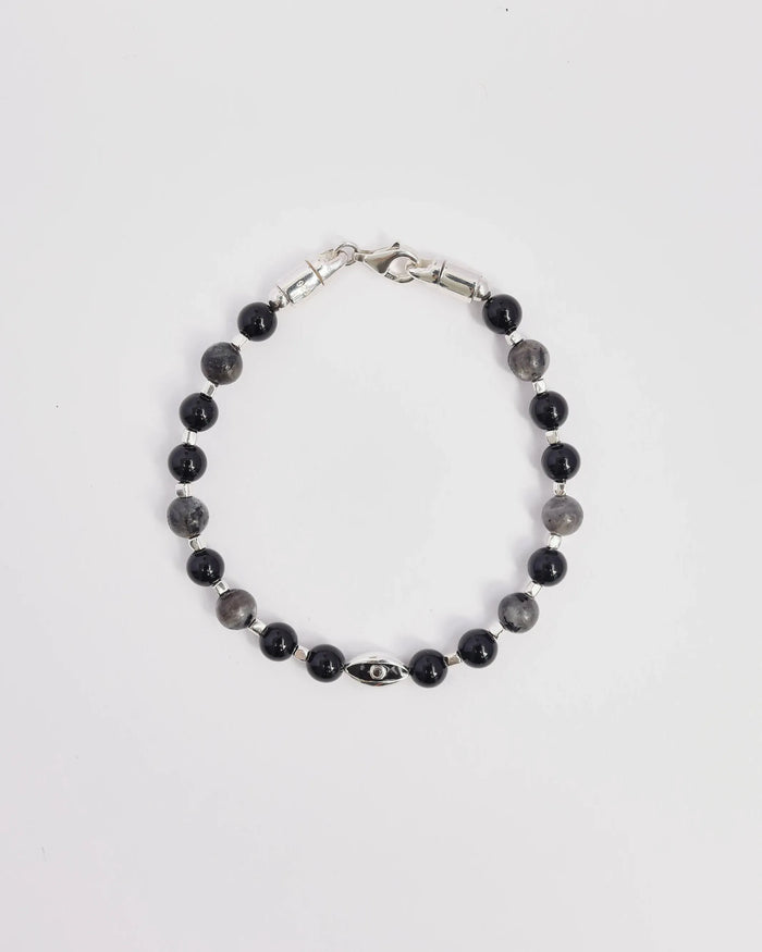 The David Bracelet in Silver laid flat, showcasing its polished silver finish, black onyx beads, and a single evil eye charm with a black CZ diamond.