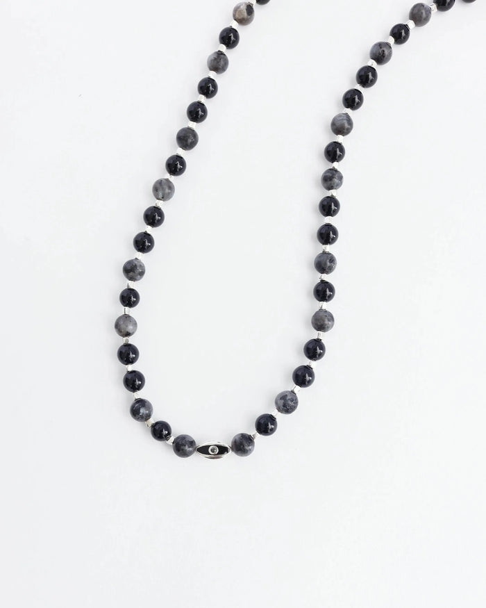 The David Wrap in Silver laid flat in a single strand, emphasizing the length, dual evil eye charms, and polished silver finish.