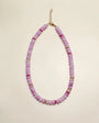 Ethan necklace in lavender displayed in a flat-lay view, featuring soft purple beads accented with pink and gold details, with a delicate chain clasp.