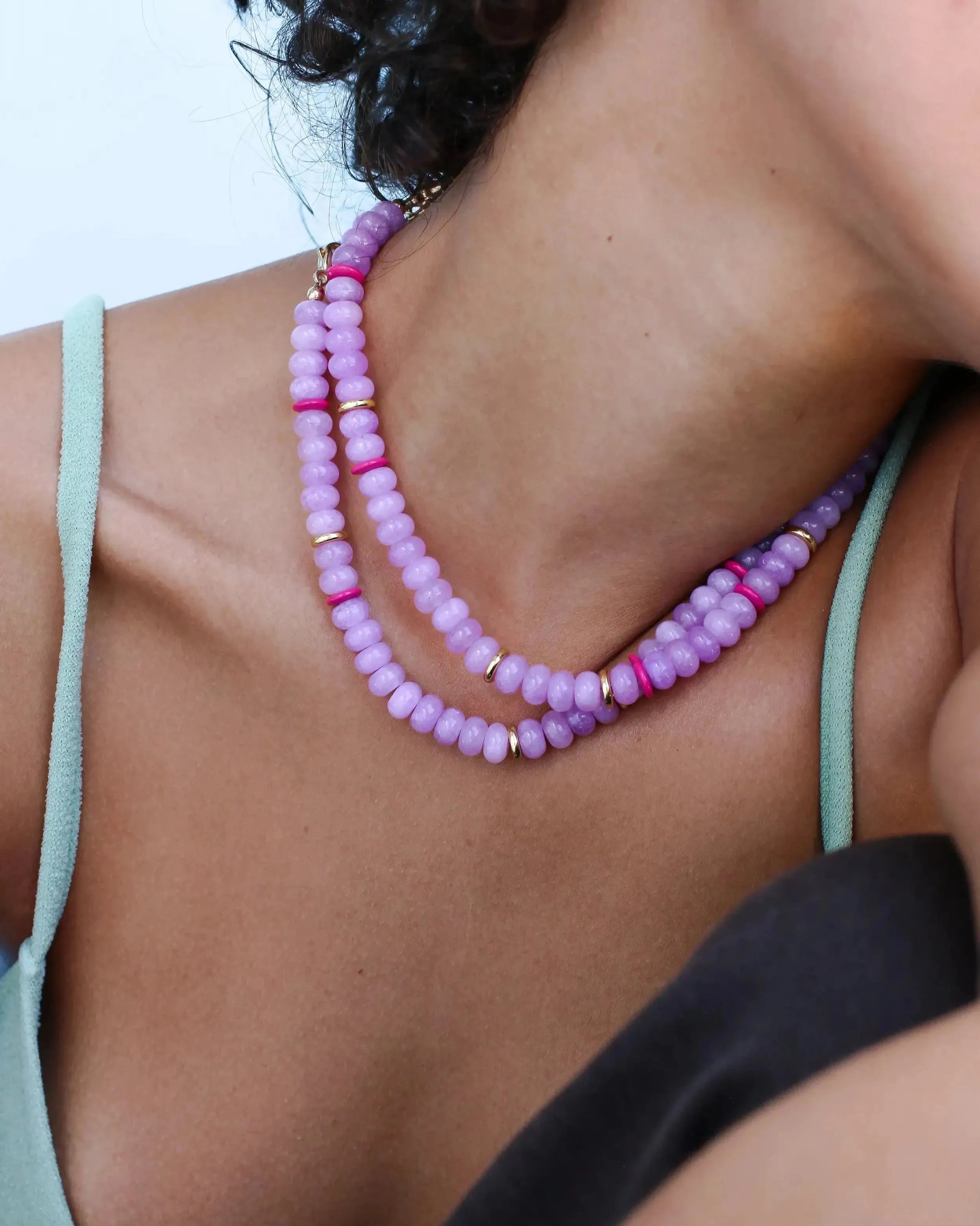 Model wearing the Ethan lavender necklace, layered for a stylish and sophisticated statement, emphasizing the delicate blend of lavender beads with pink and gold details.