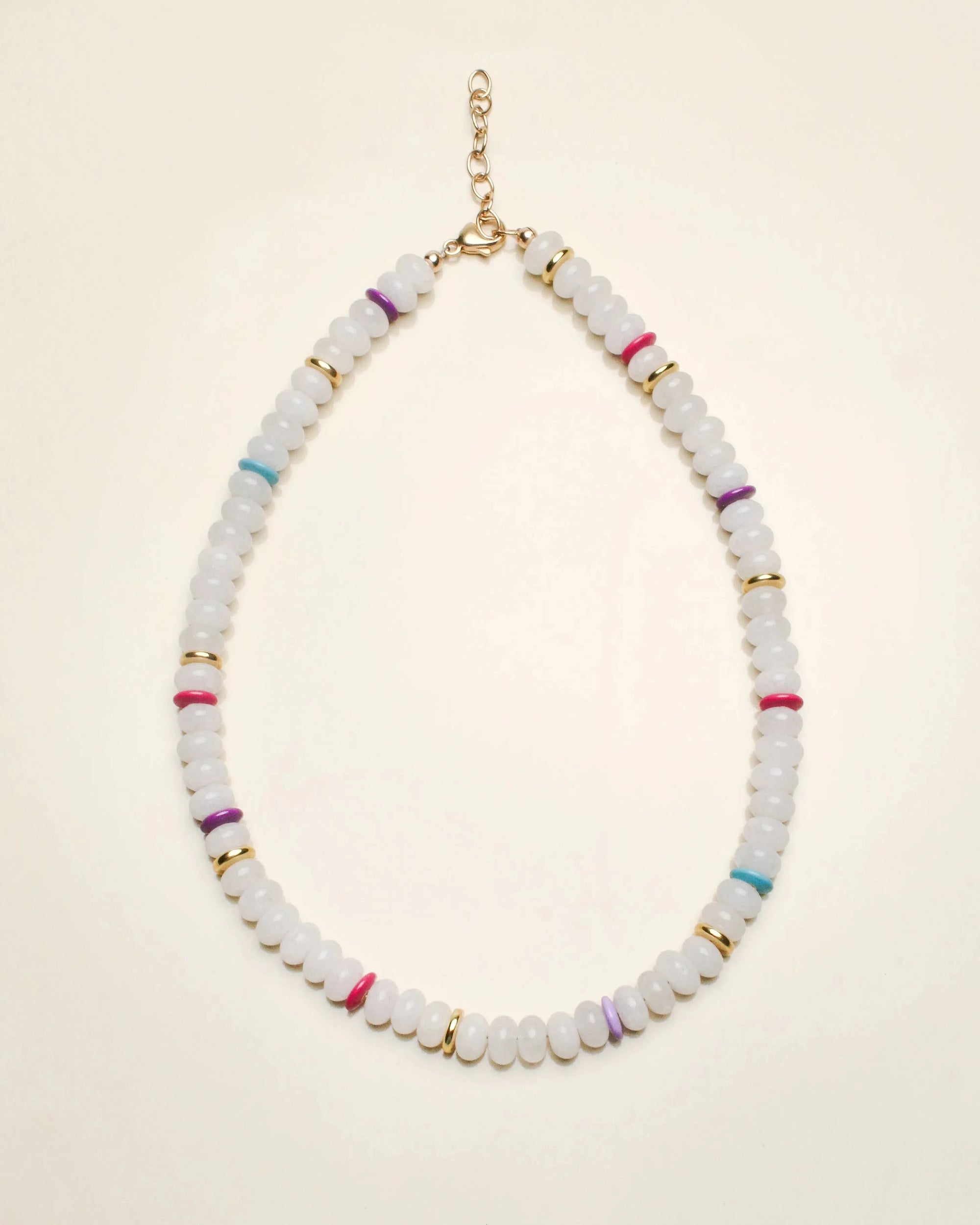 Ethan necklace in white quartz displayed in a flat-lay view, featuring milky white beads accented with multicolored dividers and gold detailing, finished with a delicate chain clasp.