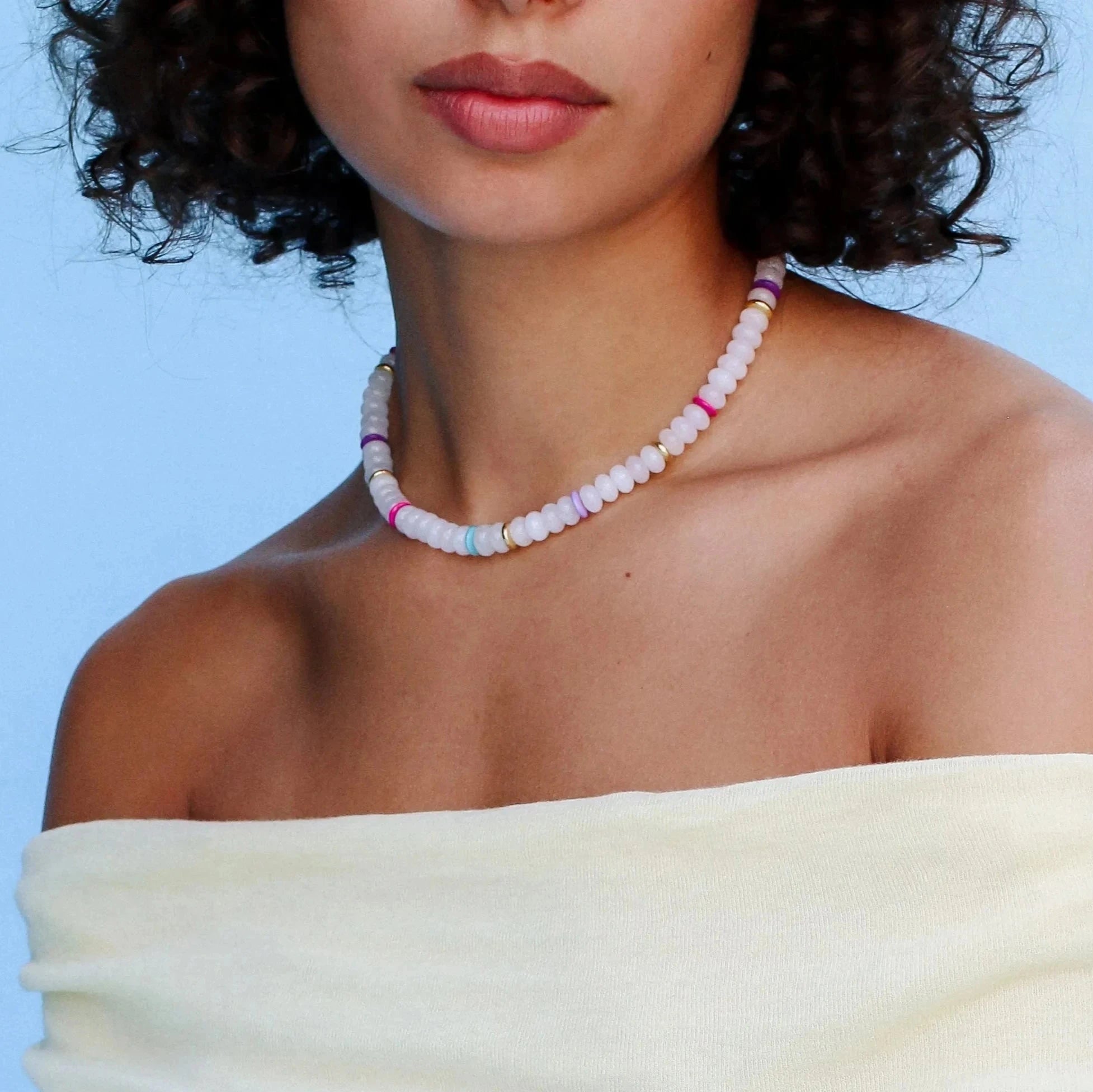 Model wearing the Ethan white quartz necklace, styled to highlight its elegant white beads and colorful dividers, adding a chic and sophisticated look.