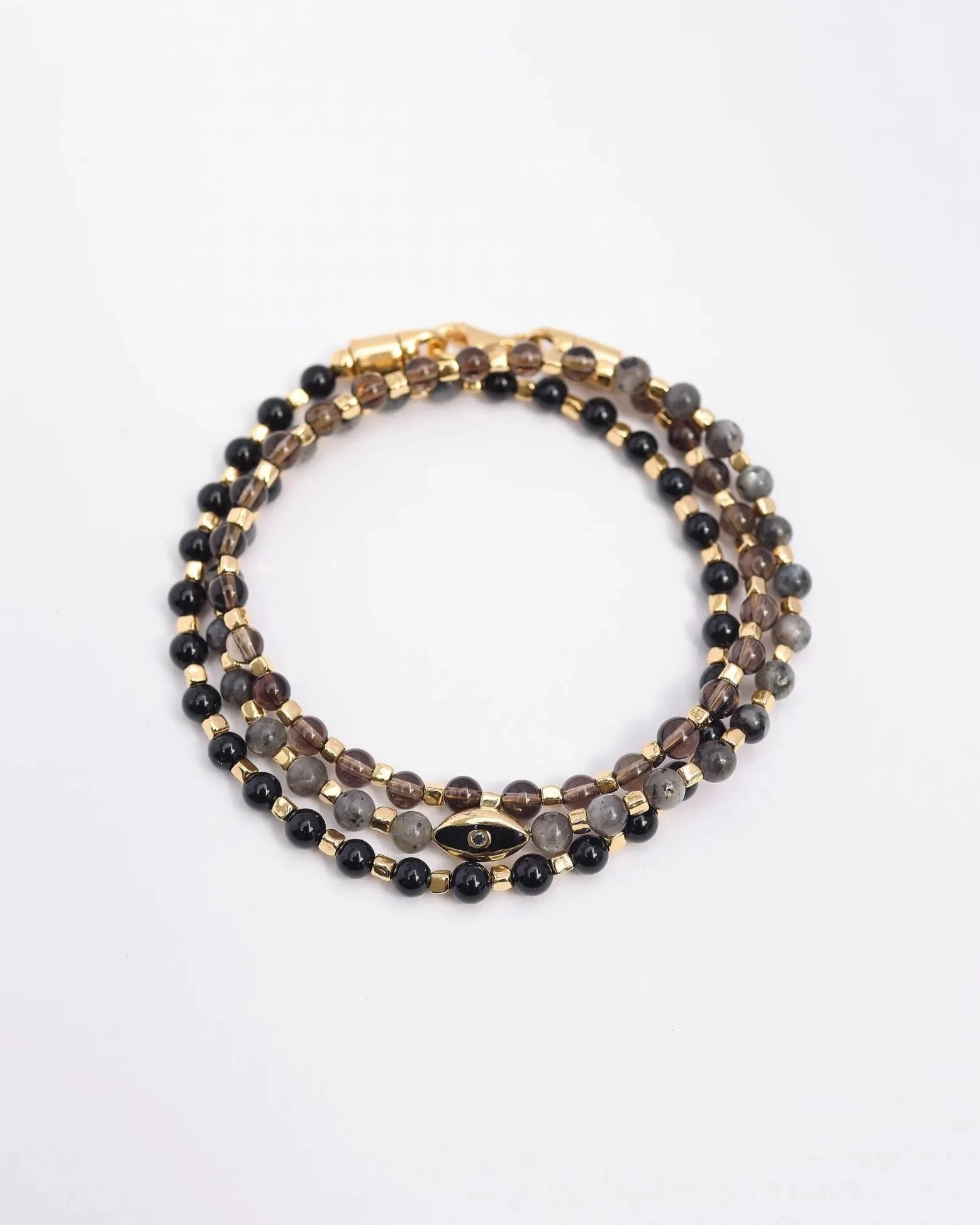 The Ethan Wrap in 18K Gold laid flat and wrapped, showcasing its luxe gold finish, 4mm black onyx, black labradorite, and smoky quartz beads, along with dual evil eye charms with black CZ diamonds.