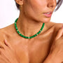 Model wearing the Fanny emerald quartz necklace, showcasing the rich green beads and shimmering solid gold and diamond accents against bare skin for a chic, luxurious look.