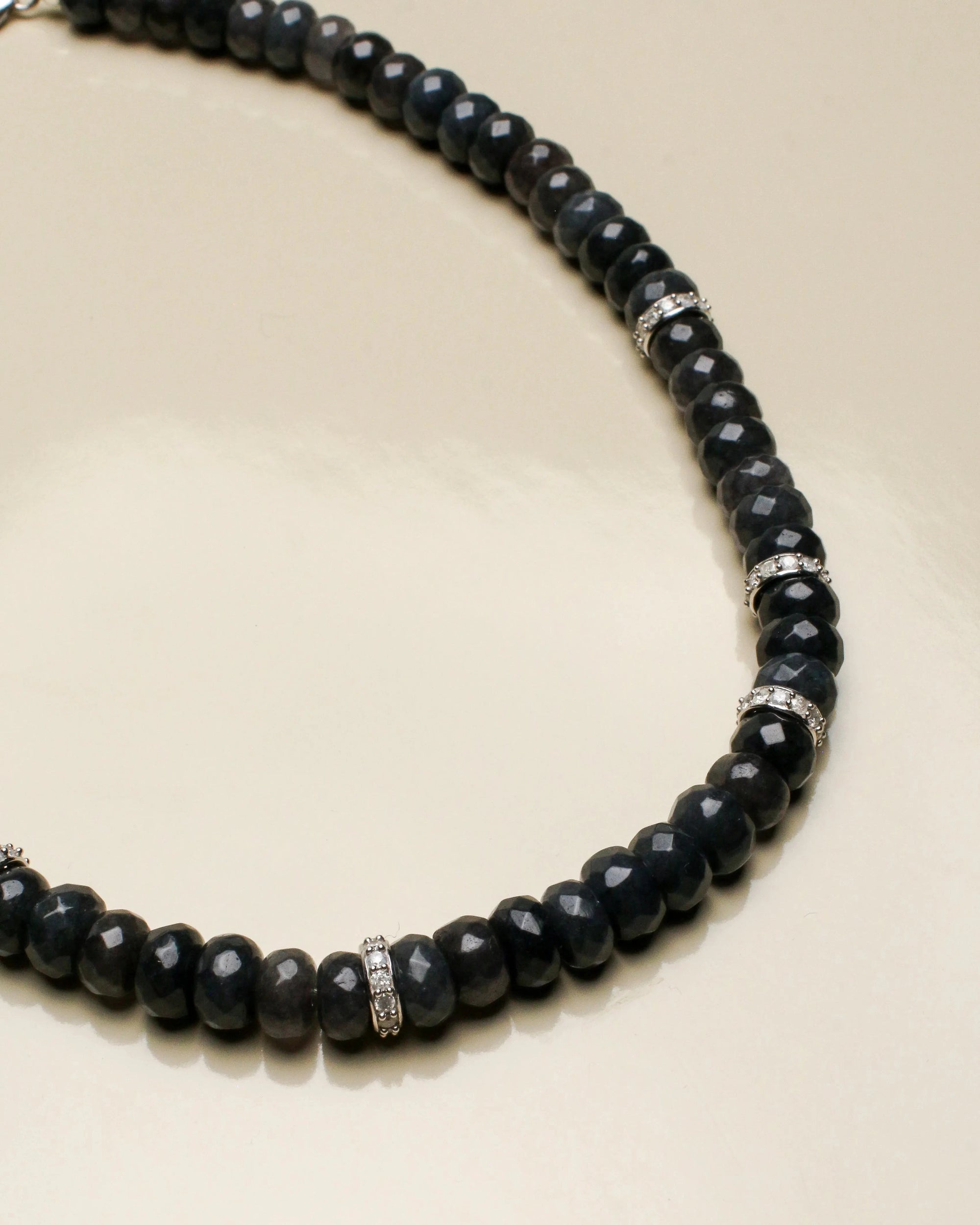 Close-up of the Fanny onyx black necklace, showcasing the striking black beads paired with gleaming white solid gold and diamond accents for a sophisticated touch.