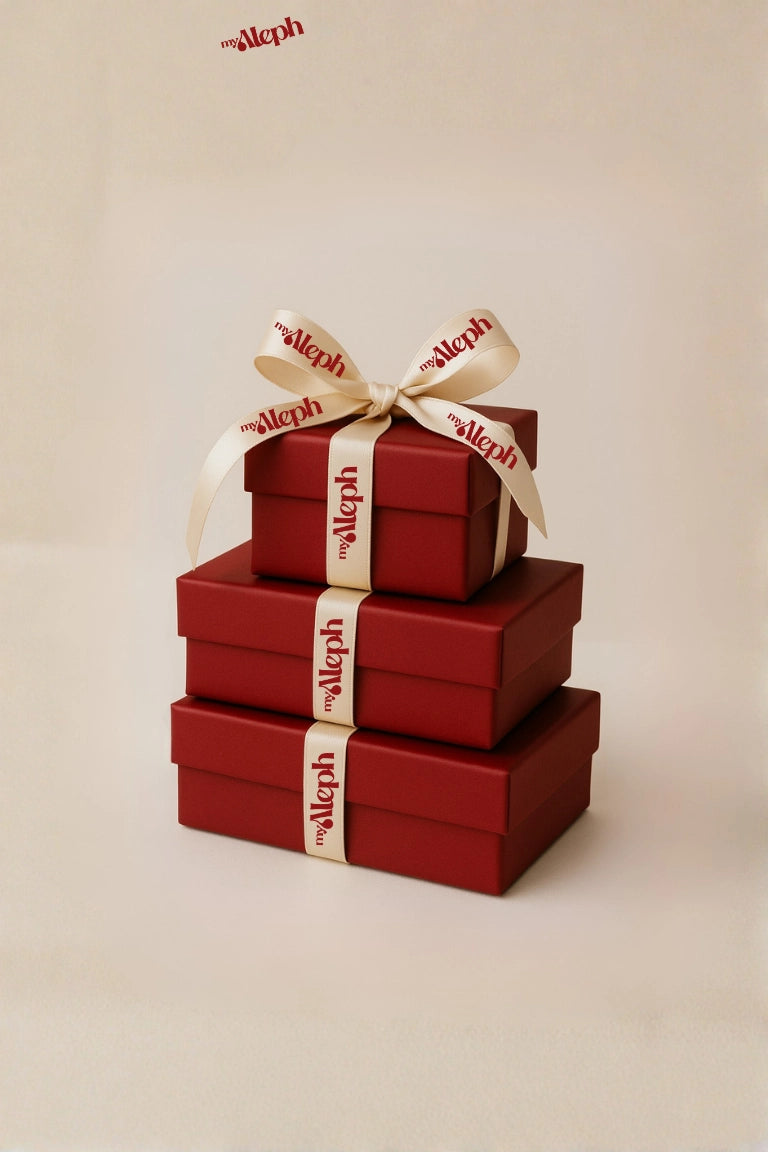 Stack of red gift boxes with a beige ribbon and 'myaleph' branding on a beige background