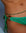 Model in green bikini wearing Juliana Belly Chain in Malachite Quartz with Evil Eye Charm at waist