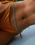 Close-up of model in yellow bikini wearing Juliana Belly Chain in Turquoise Quartz at waist