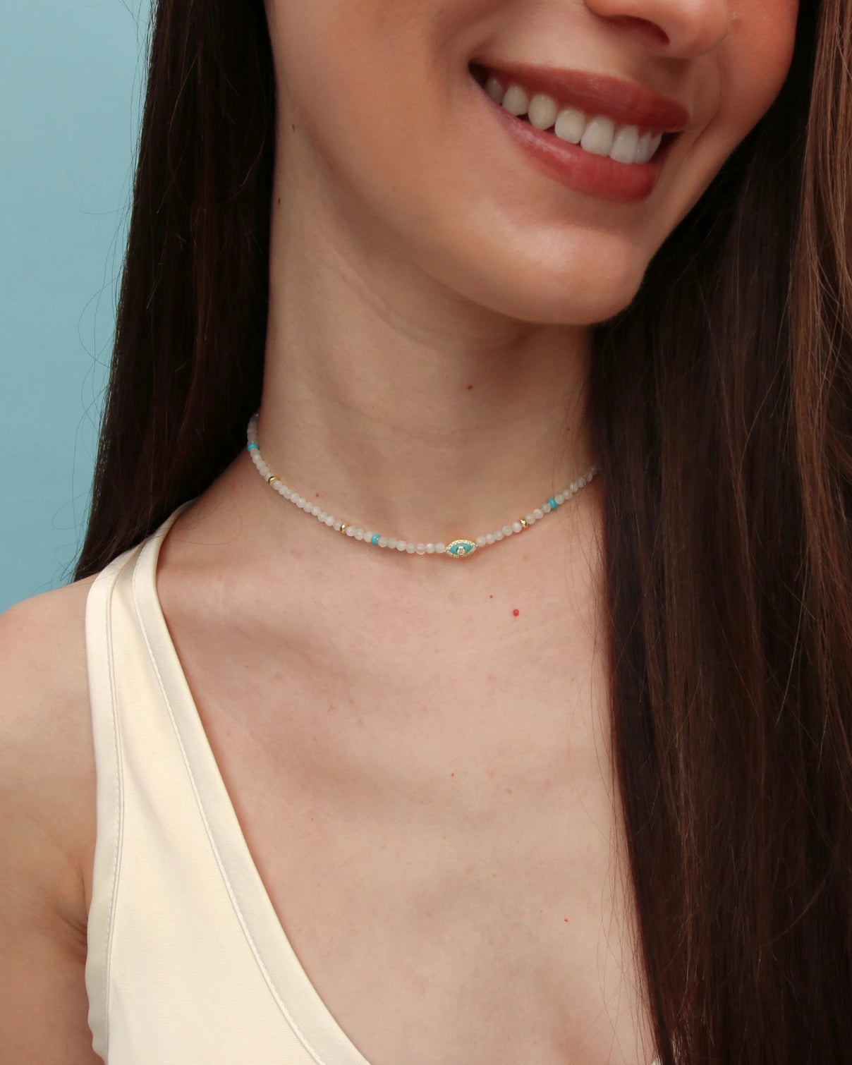 Model wearing the Juliana Necklace in Moonstone with a sleeveless white top, showcasing the light-catching iridescence of the beads.