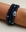 A set of three Leah sapphire quartz bracelets worn on the wrist, featuring deep blue beads with silver accents and a prominent evil eye charm for a striking layered look.