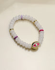 A single Leah white bracelet arranged flat, highlighting the milky white beads, colorful dividers, and the central eye charm for a bright and balanced design.