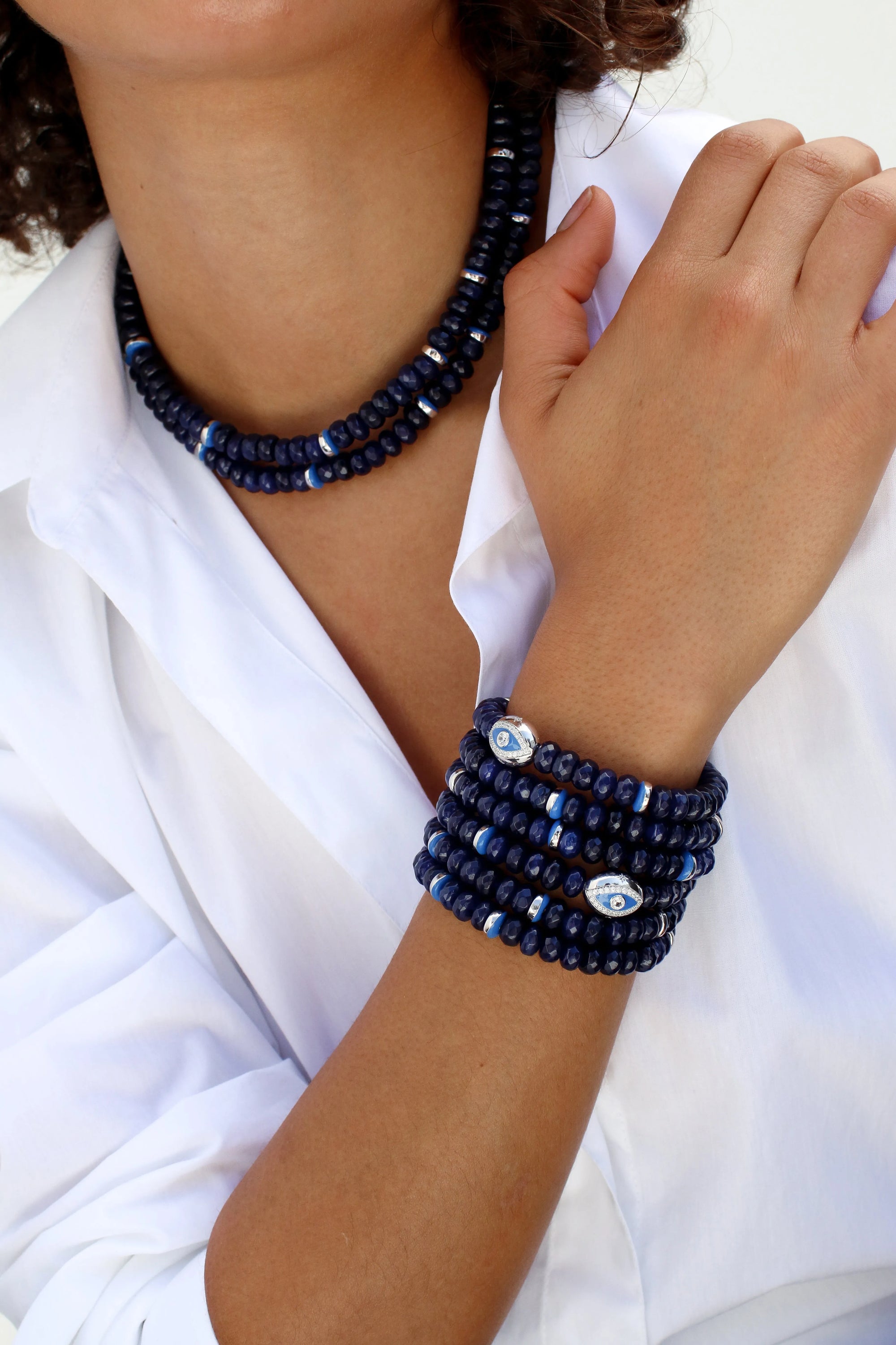 Model wearing the Lilou necklace in sapphire quartz, paired with matching bracelets, showcasing the deep blue beads and silver accents for a coordinated, elegant ensemble.