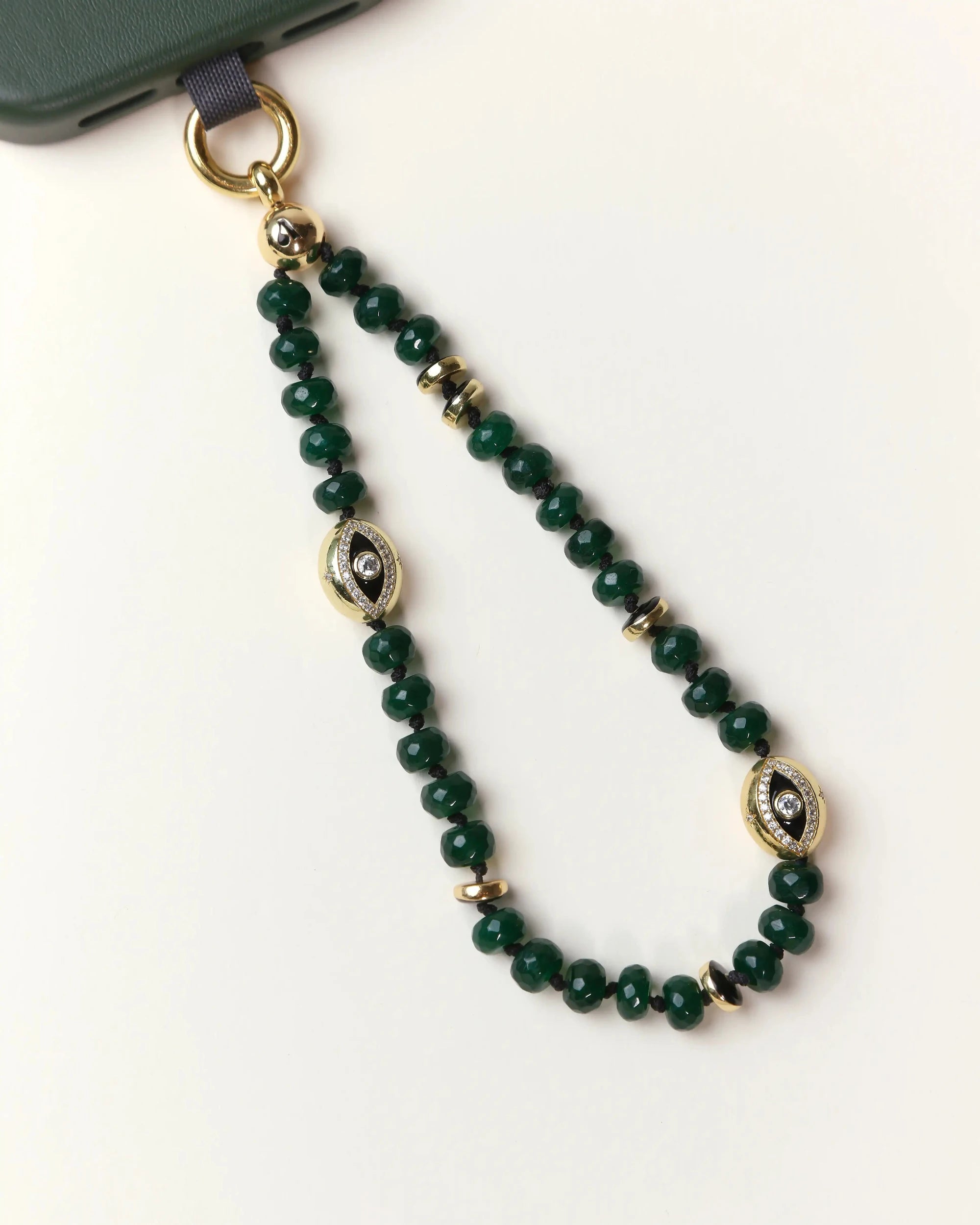 Emerald Leah  Phone Charm displayed in looped form, highlighting gemstone color and gold finishes.