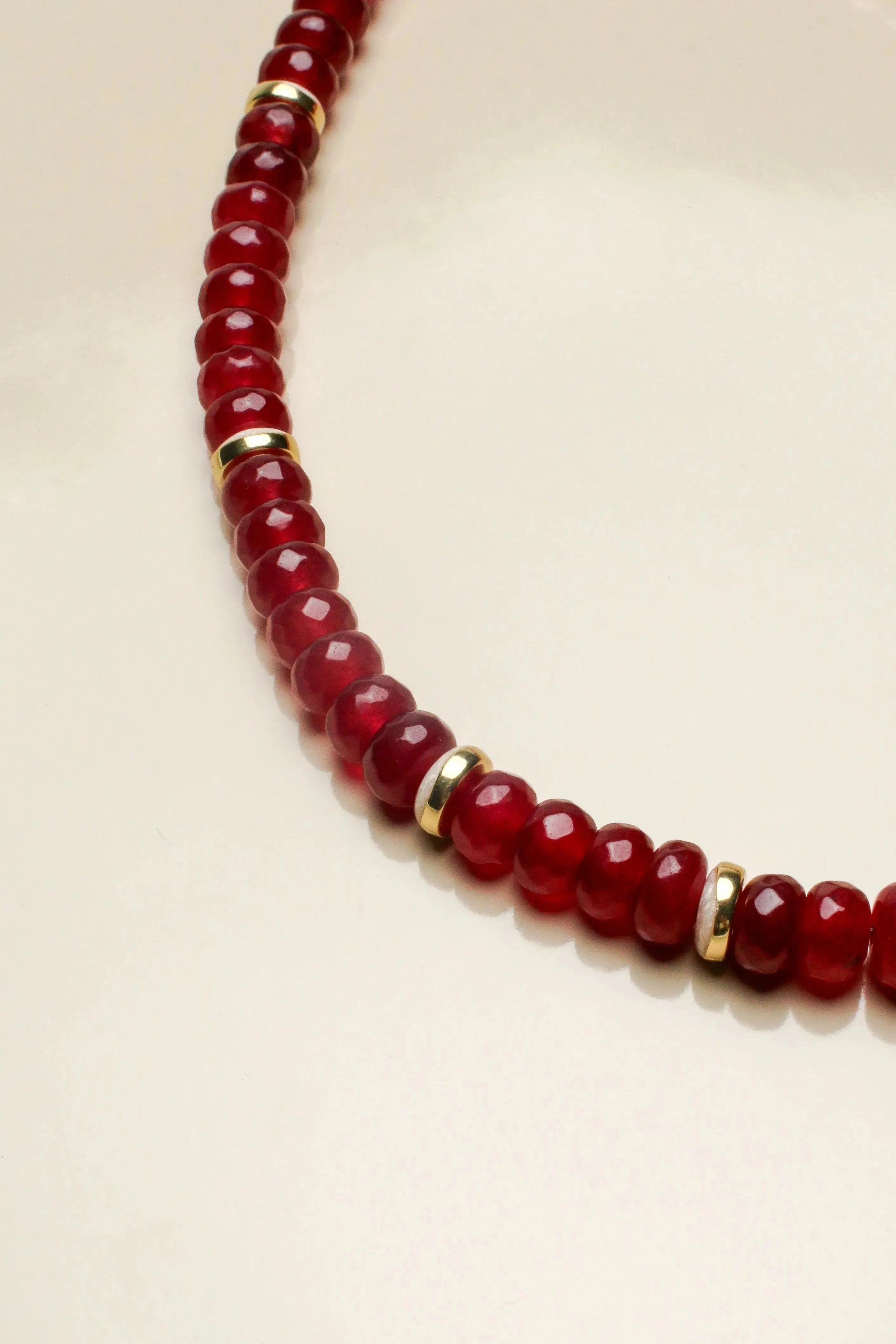 Close-up of the Lilou cherry quartz necklace, highlighting the rich red beads and gold accents that provide a luxurious and striking appearance.