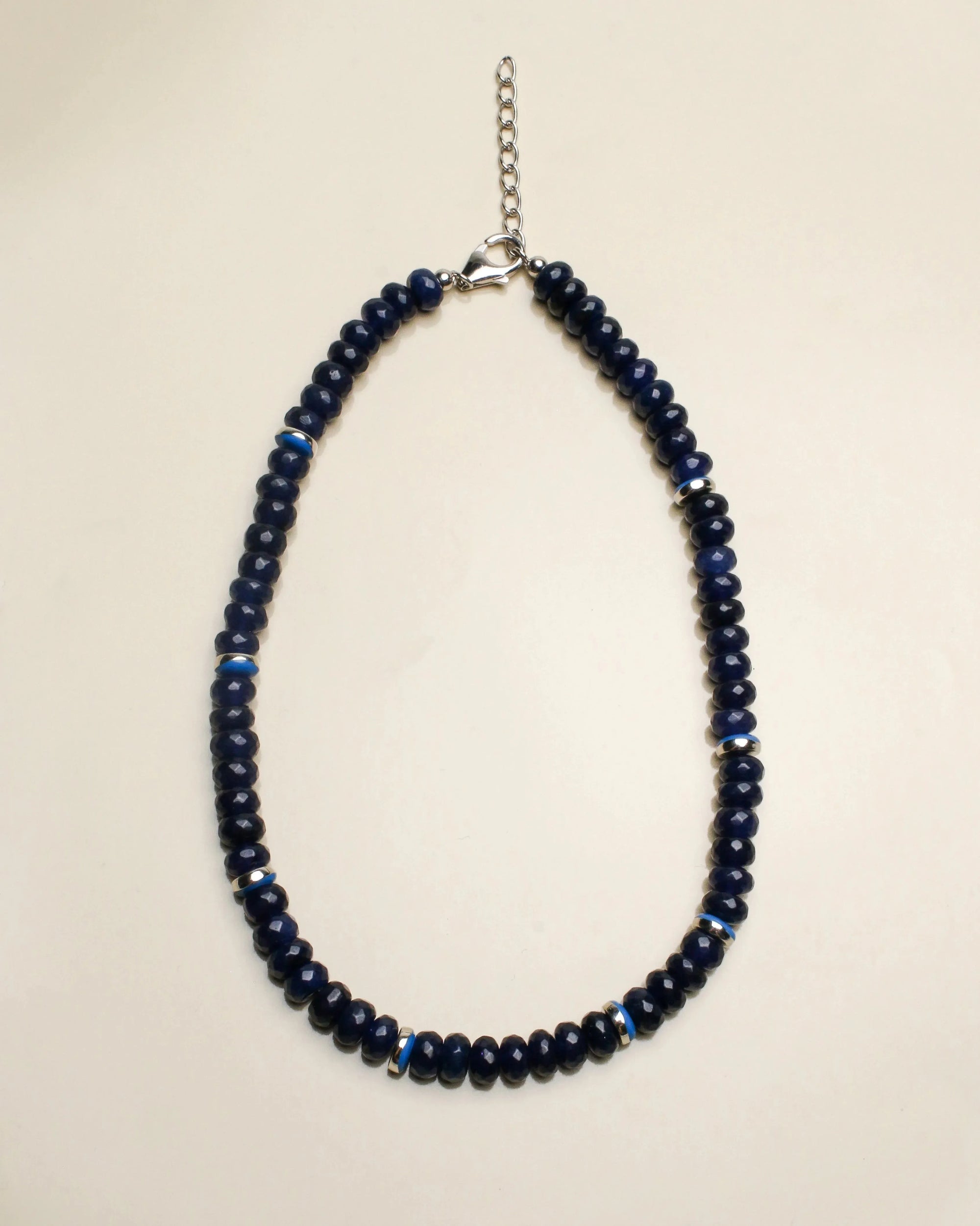 Lilou necklace in sapphire quartz displayed flat, featuring deep blue beads with silver accents and a delicate chain clasp, offering a refined and elegant style.