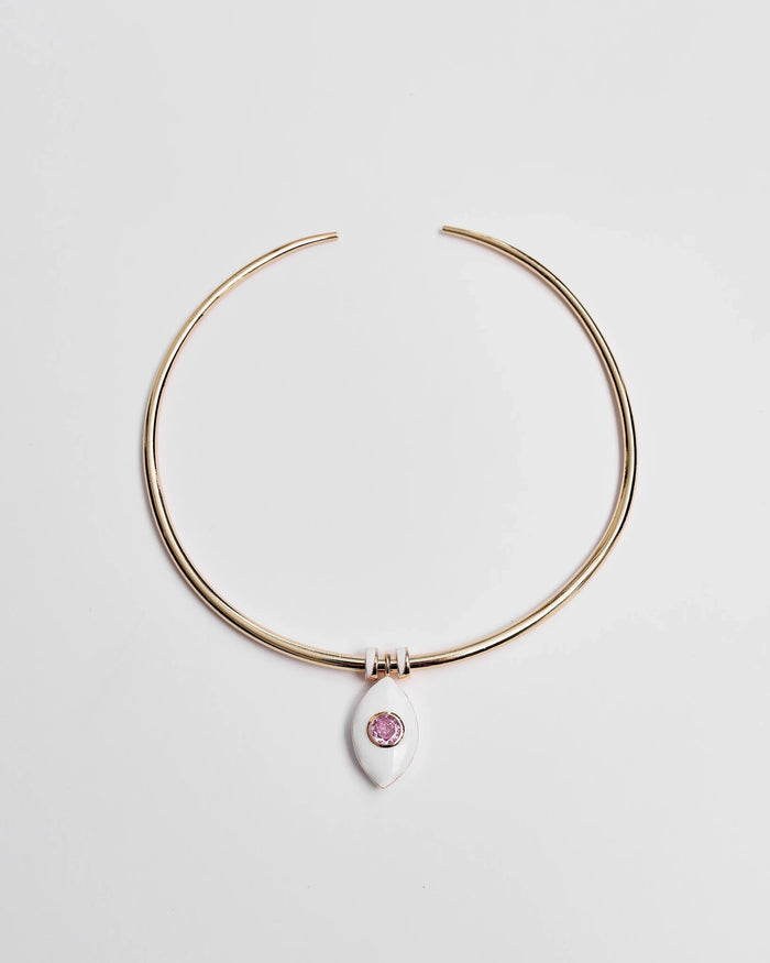 Gold collar necklace featuring a ceramic evil eye charm with a soft pink CZ crystal and two white enamel dividers, shown flat against a white background