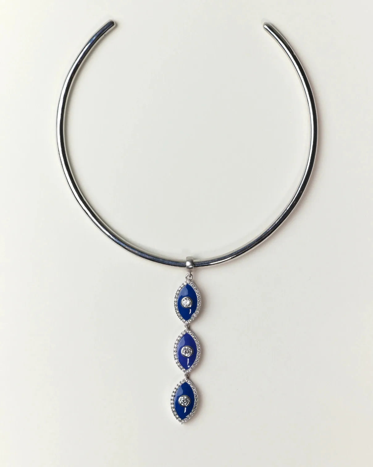 Silver necklace with blue evil eye pendant on a white background