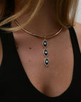 Model wearing the Mayra Collar Necklace – Charm Trio with a black top, showcasing its drop pendant design.