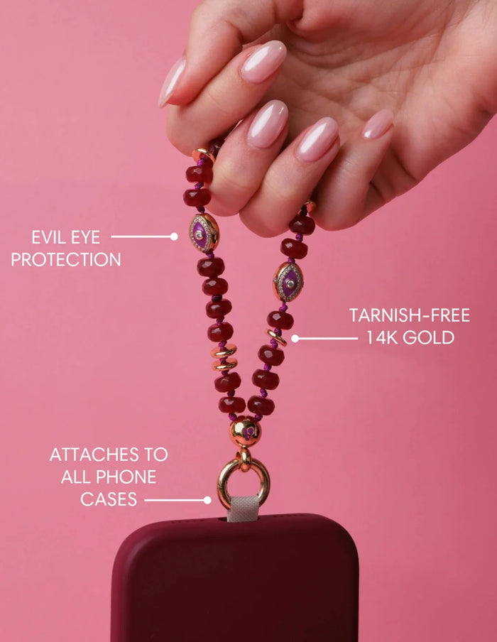 Mini Leah Ruby Quartz Phone Charm showing evil eye protection and tarnish-free 14k gold hardware.