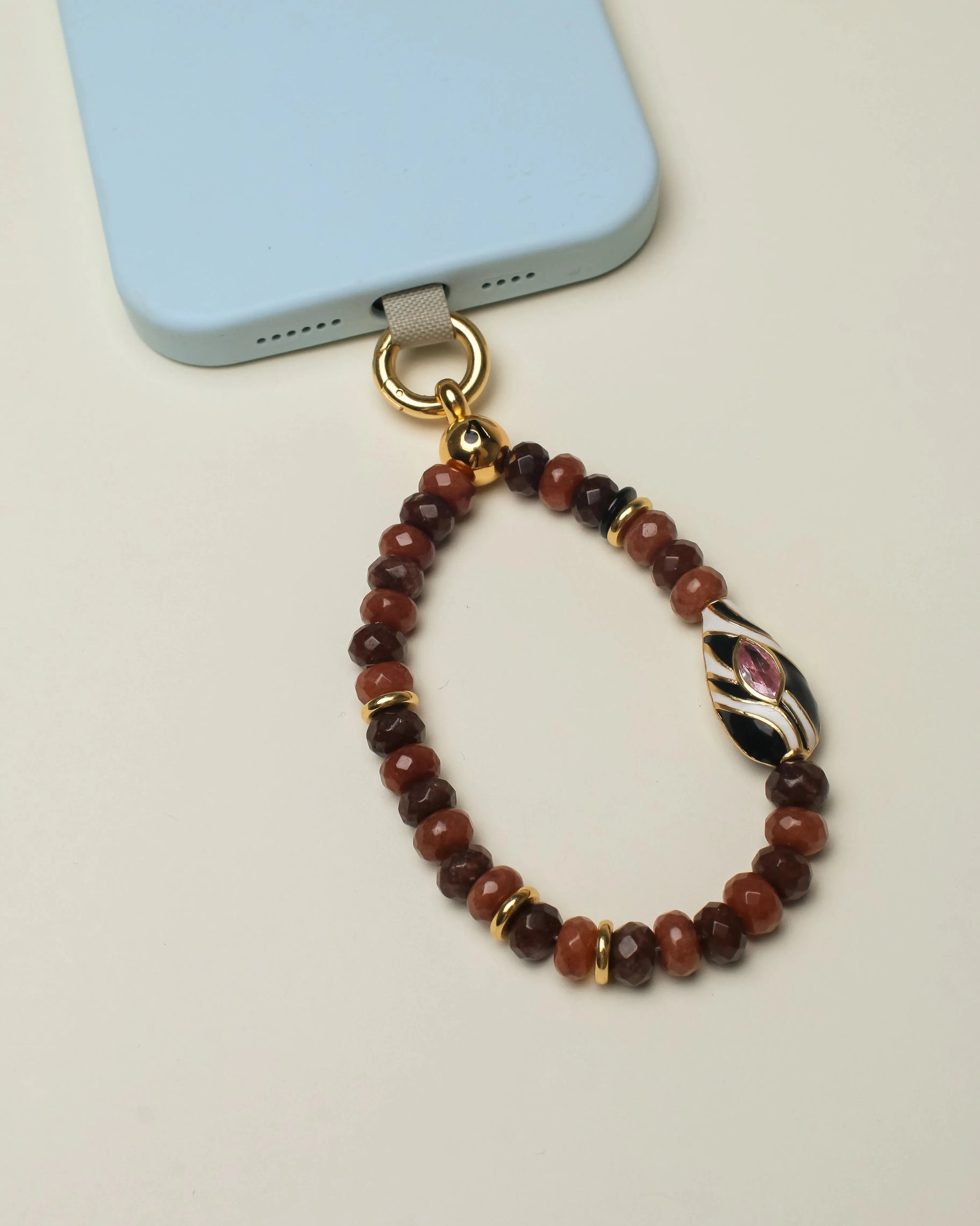 Close-up of the Minou Mini Wristlet in Espresso, highlighting its multi-toned brown quartz stones and Zebra Evil Eye charm against a clean background.