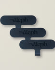 A set of three black MyAleph wristlet cards, designed for securely attaching phone wristlets to most phone cases.