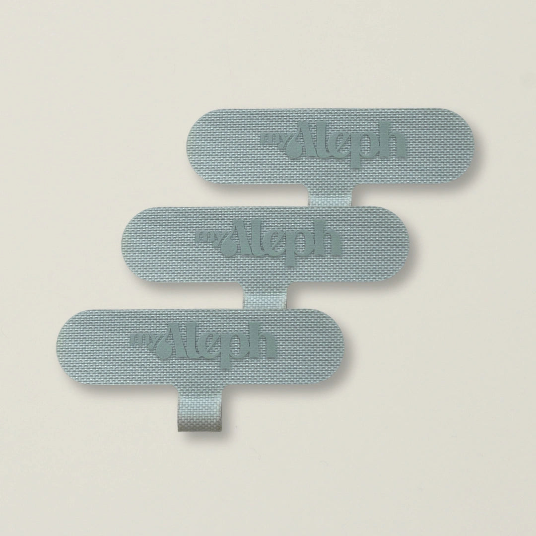 A set of three gray MyAleph wristlet cards, offering a universal fit for easy phone wristlet attachment.