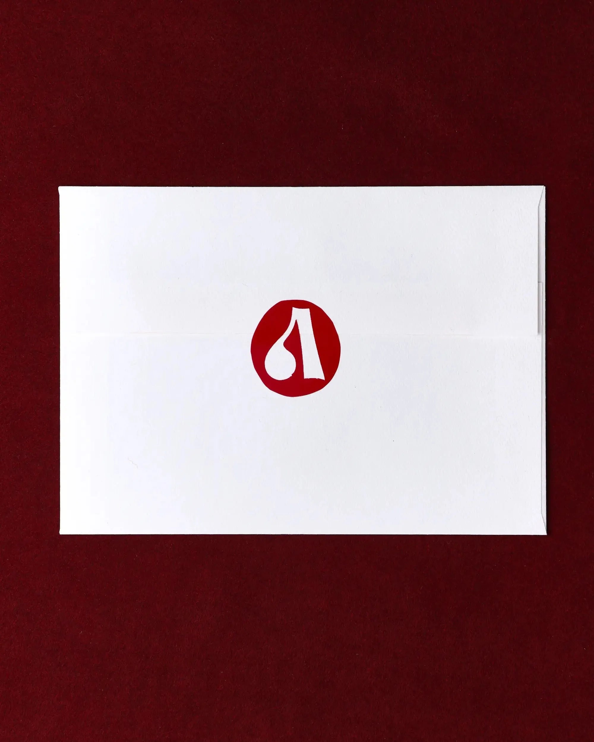 White card with a red logo on a maroon background