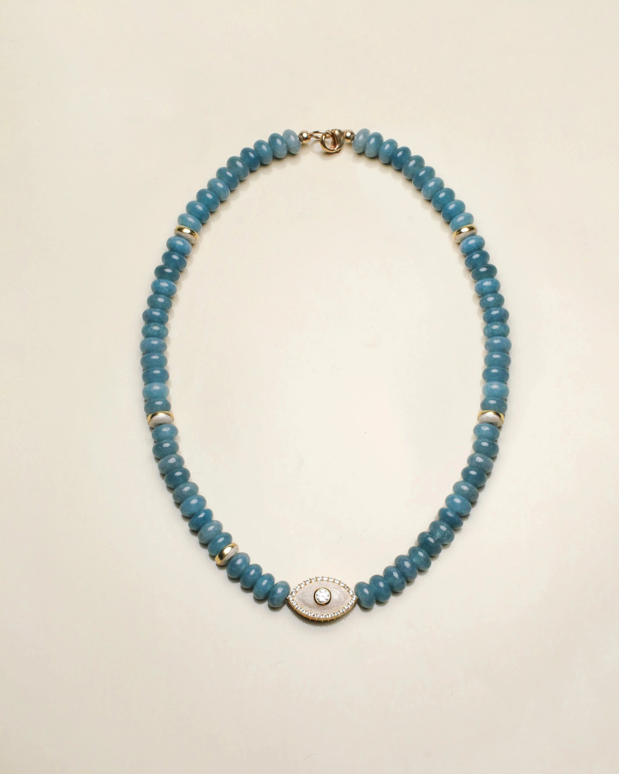 Stella necklace crafted with apatite quartz beads, featuring a centerpiece of a white charm with a subtle, polished finish and gold accents.