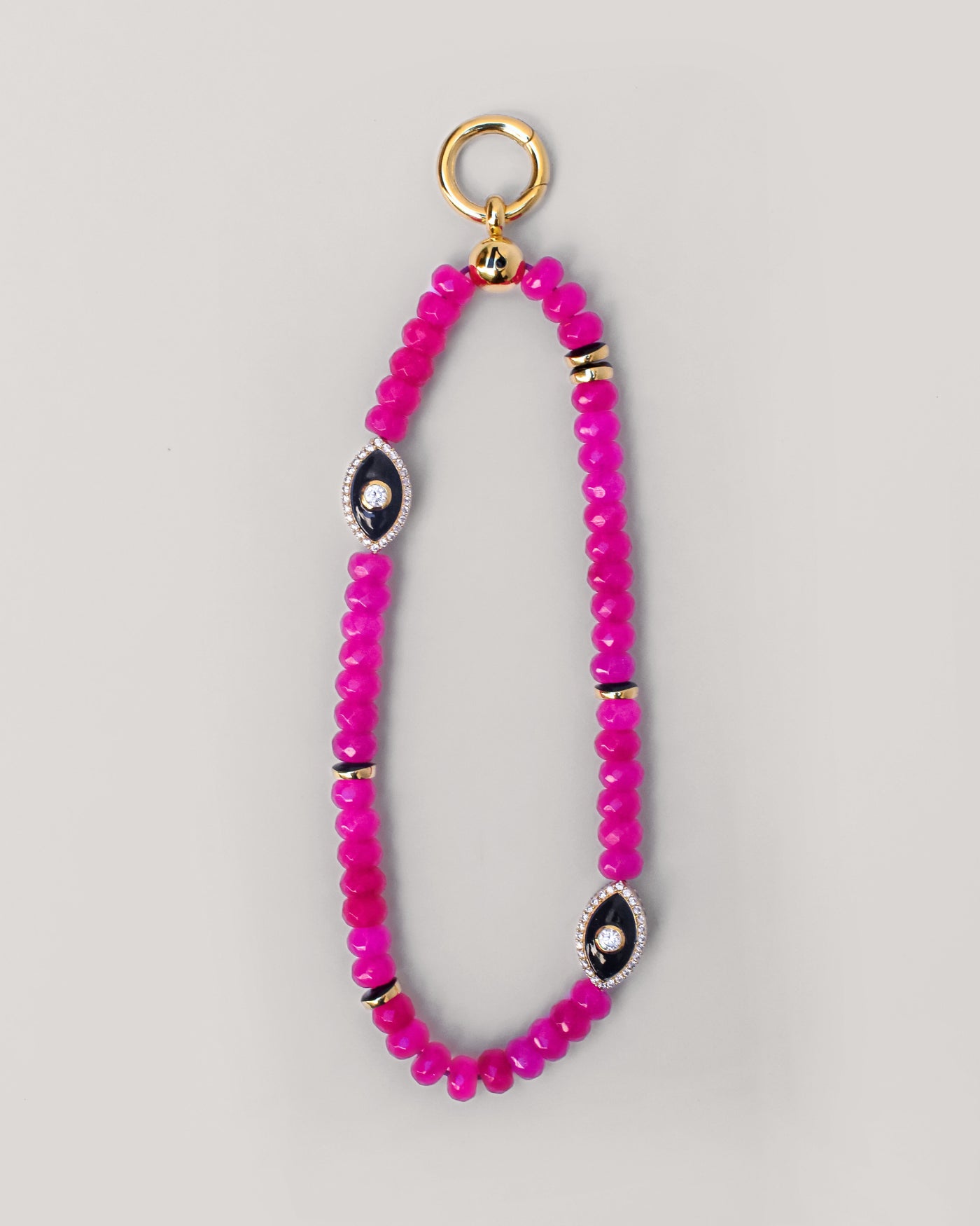 Full view of the Stella phone wristlet with pink quartz beads and evil eye charm, elegantly looped and ready to be attached to a phone or bag.