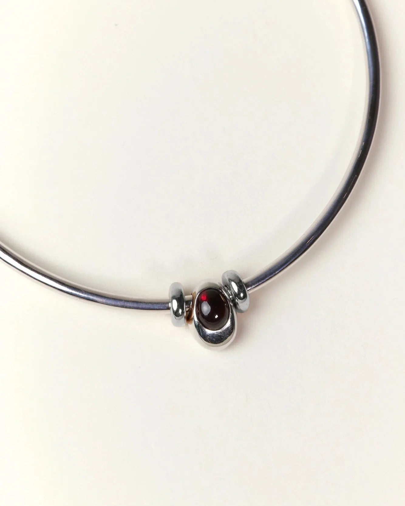 Close-up of the Terre necklace showing a single gemstone charm set in premium silver dipped hardware.