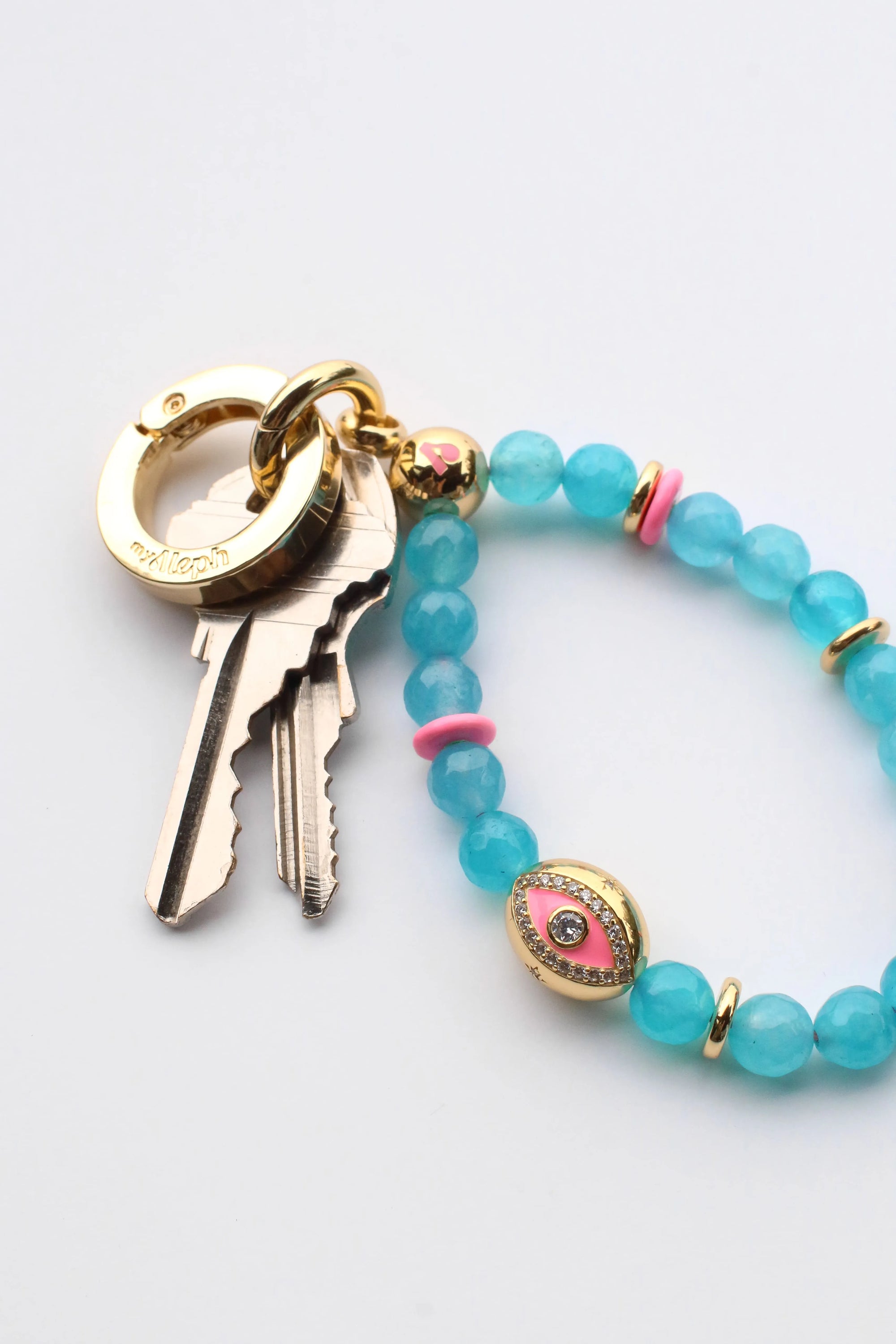 The Ring accessory used as a stylish keyring holder, paired with colorful MyAleph wristlets and charms, showcasing its versatility.