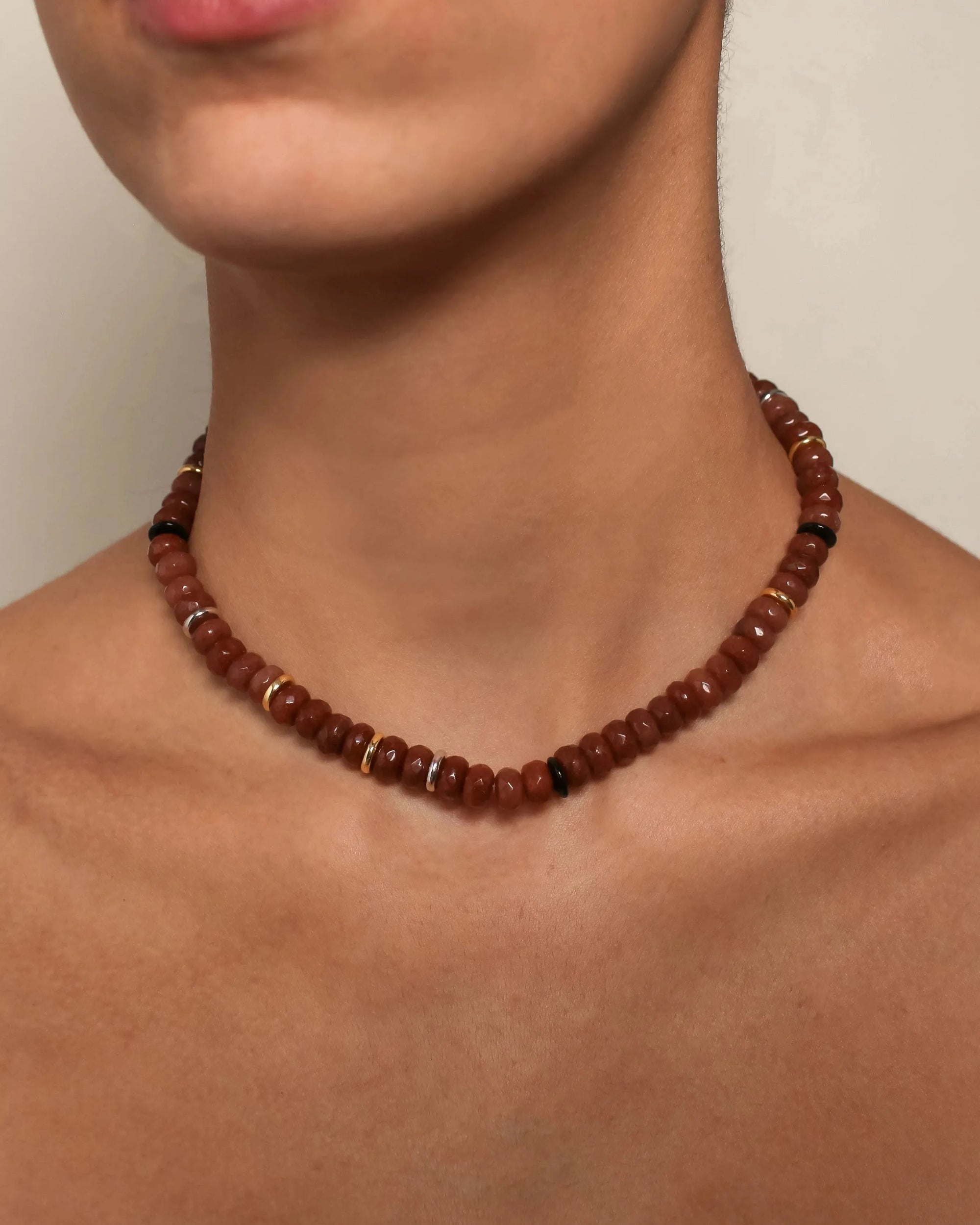 Detailed view of the Valerie Necklace in Caramel, elegantly resting on a model's collarbone, emphasizing its timeless design.