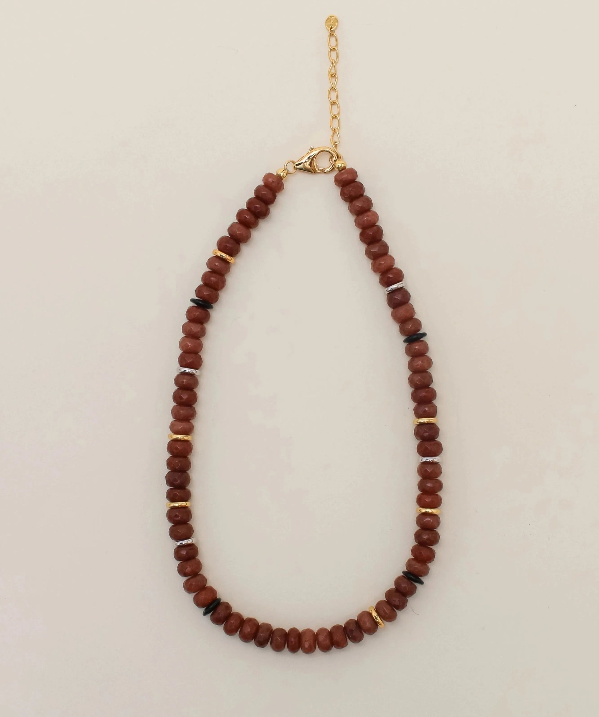 The Valerie Necklace in Caramel, featuring warm caramel quartz beads with gold-plated accents and an adjustable gold chain, displayed against a neutral background.