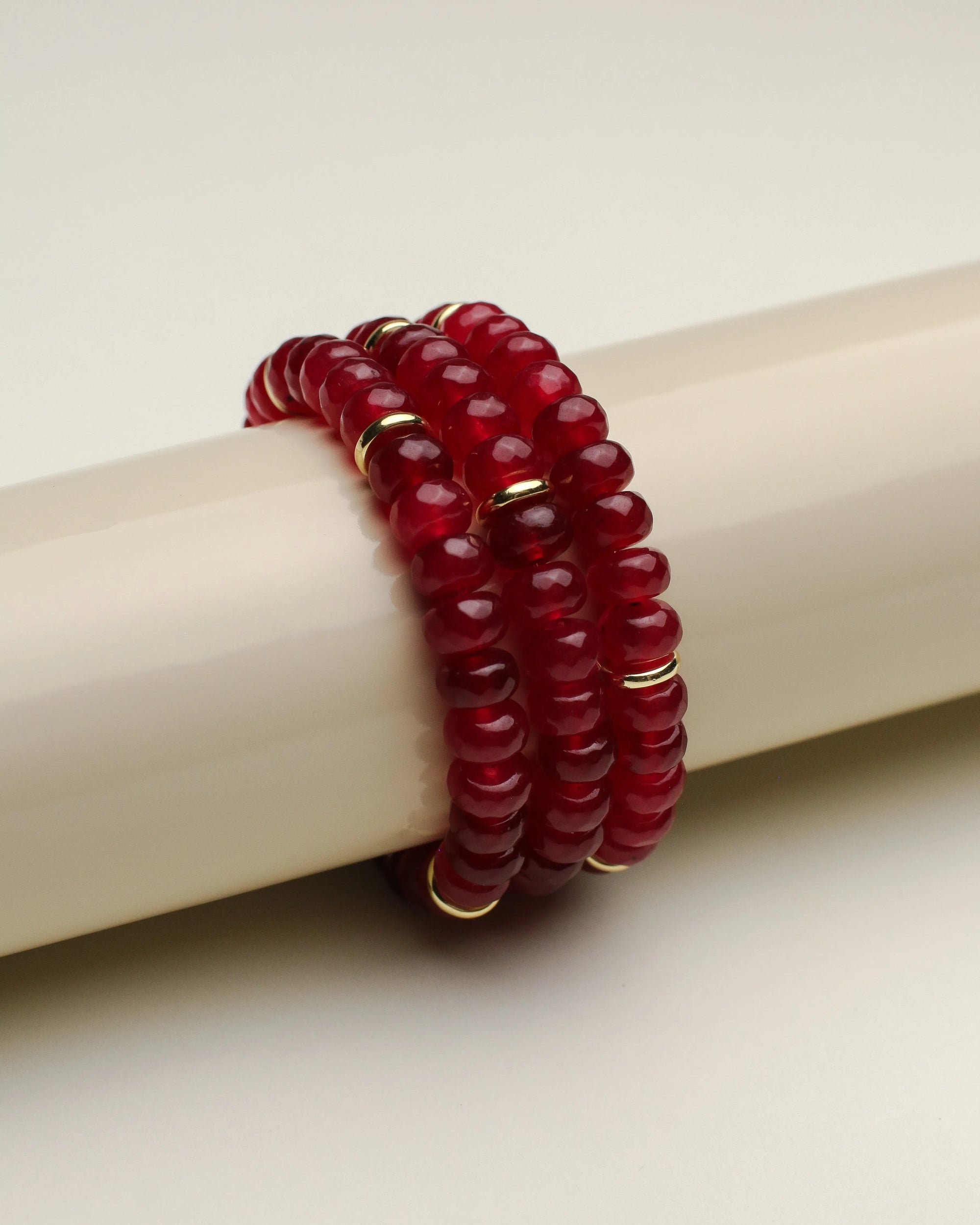 Side view of the Zoe cherry quartz bracelets set, highlighting the smooth, rounded beads and lustrous finish.