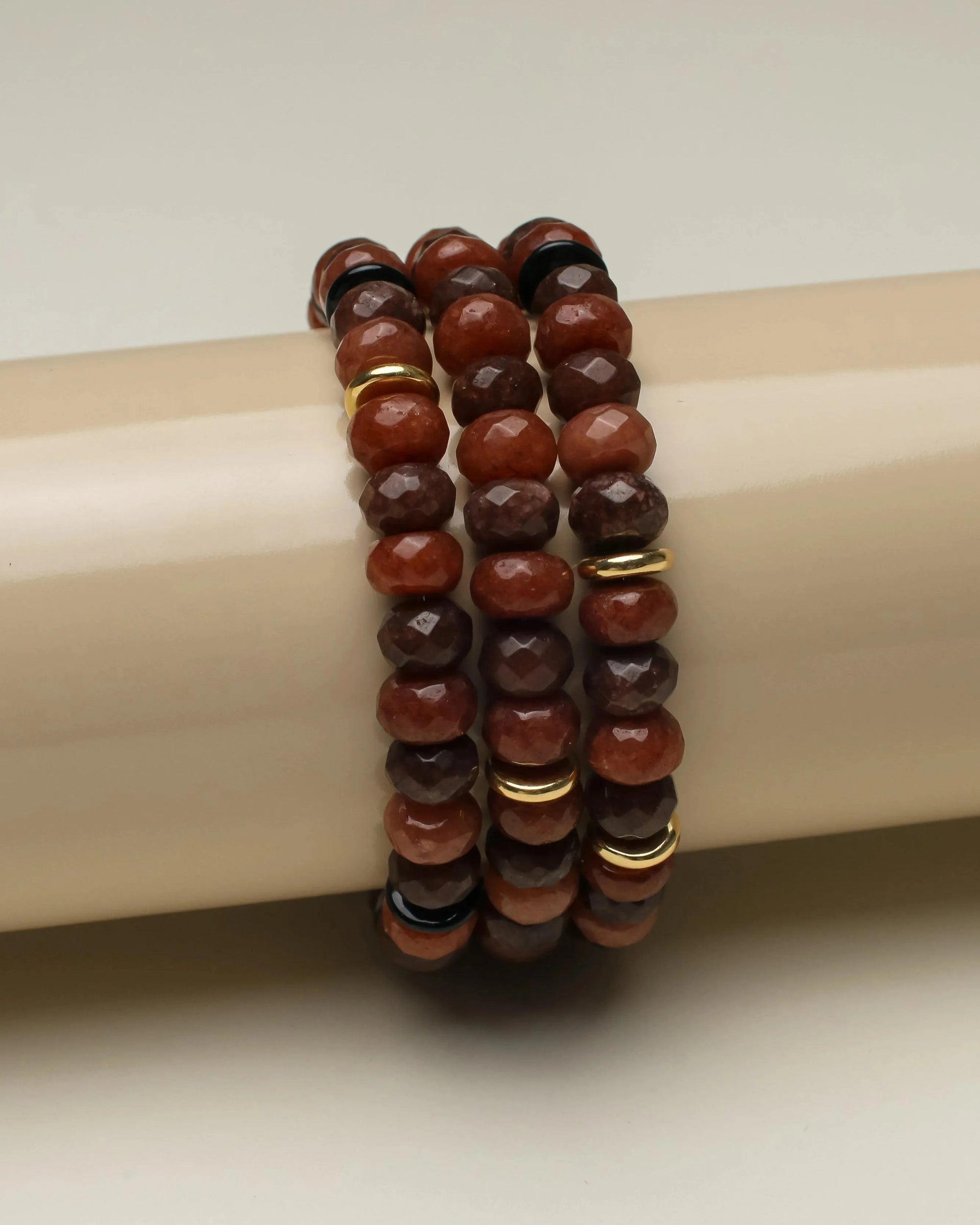 Close-up of the Zoe Bracelet Set in Espresso, neatly stacked to showcase the rich brown quartz beads with vibrant dividers.