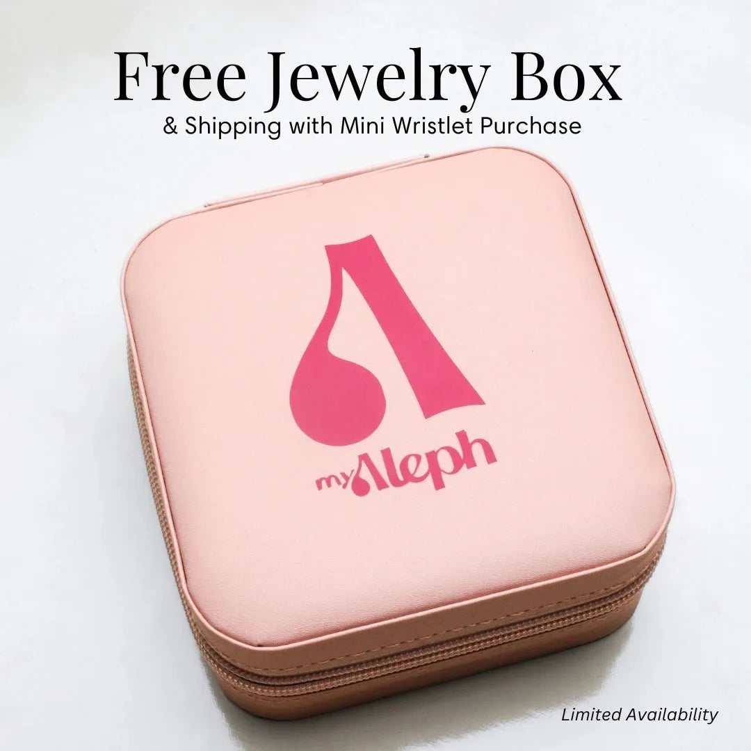 A pink jewelry box with a zipper closure, featuring the &quot;myAleph&quot; logo in bold pink on the lid. The text above the box reads &quot;Free Jewelry Box &amp; Shipping with Mini Wristlet Purchase&quot; in elegant black font, with &quot;Limited Availability&quot; in smaller text at the bottom right corner. The jewelry box has a sleek, compact design, suggesting it is ideal for storing accessories or gifts.