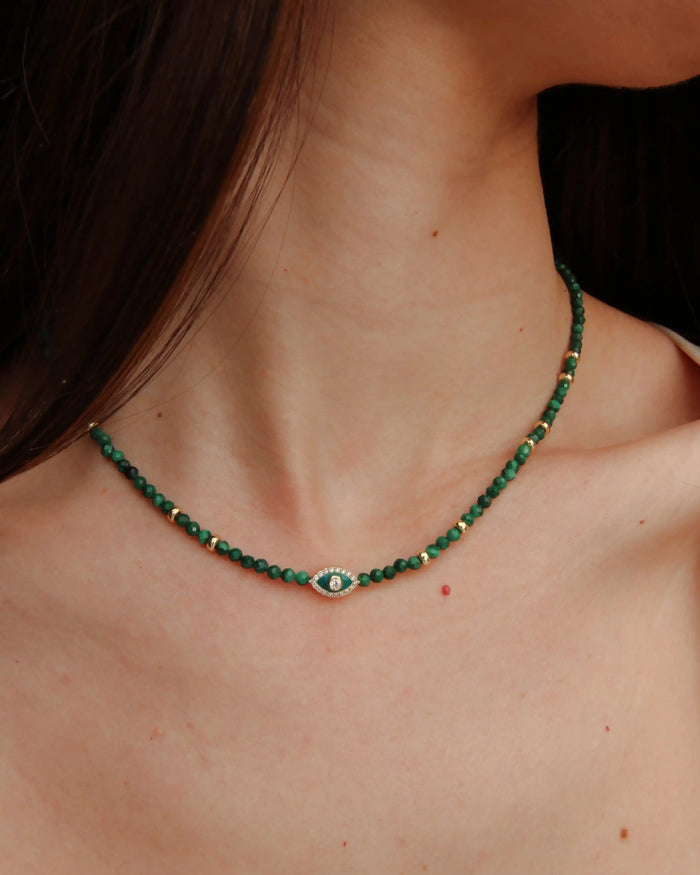 Side view of model wearing the Julianna Necklace in Malachite, showing how the necklace contours the neckline.