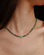Side view of model wearing the Julianna Necklace in Malachite, showing how the necklace contours the neckline.